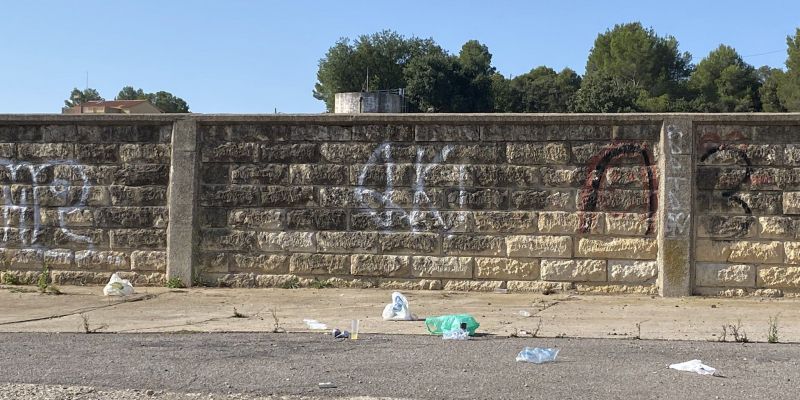 Deixalles d'un botellón al costat del mur de les antigues piscines. FOTO: Cedida