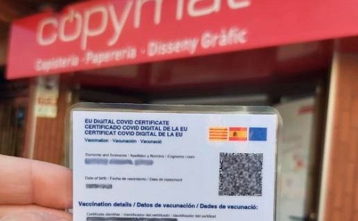 Un passaport covid amb la copisteria Copymat de fons. FOTO: Cedida